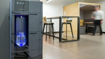 A B3 water dispenser positioned against a wall in a student working area