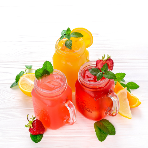 Three glasses of water positioned in a pyramid shape, all filled with a different cordial : orange, strawberry, and raspberry cordial variants. 