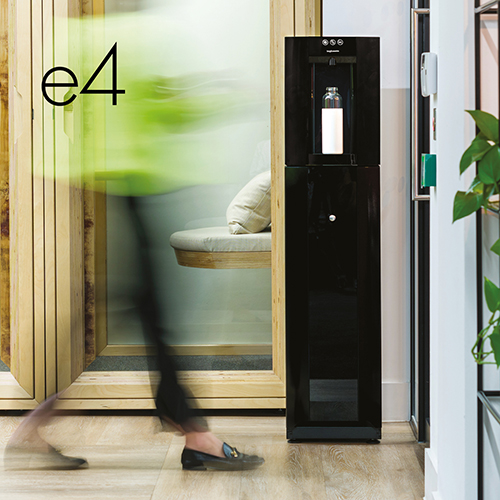 A Borg & Overström floor standing E4, styled 'black', in an office setting with a water bottle located in the dispense space.