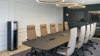 Board room with water dispenser with illuminated touch free dispense