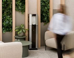 Person walking up to water cooler in modern office