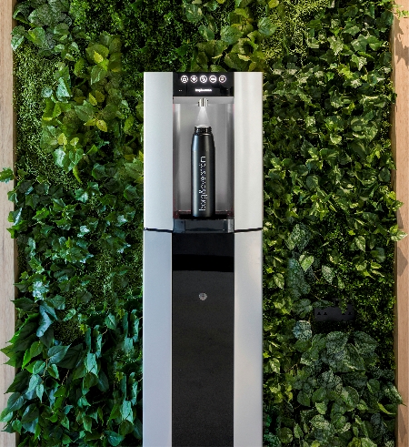 Borg & Overstrom E6 water dispenser with water bottle on living wall background