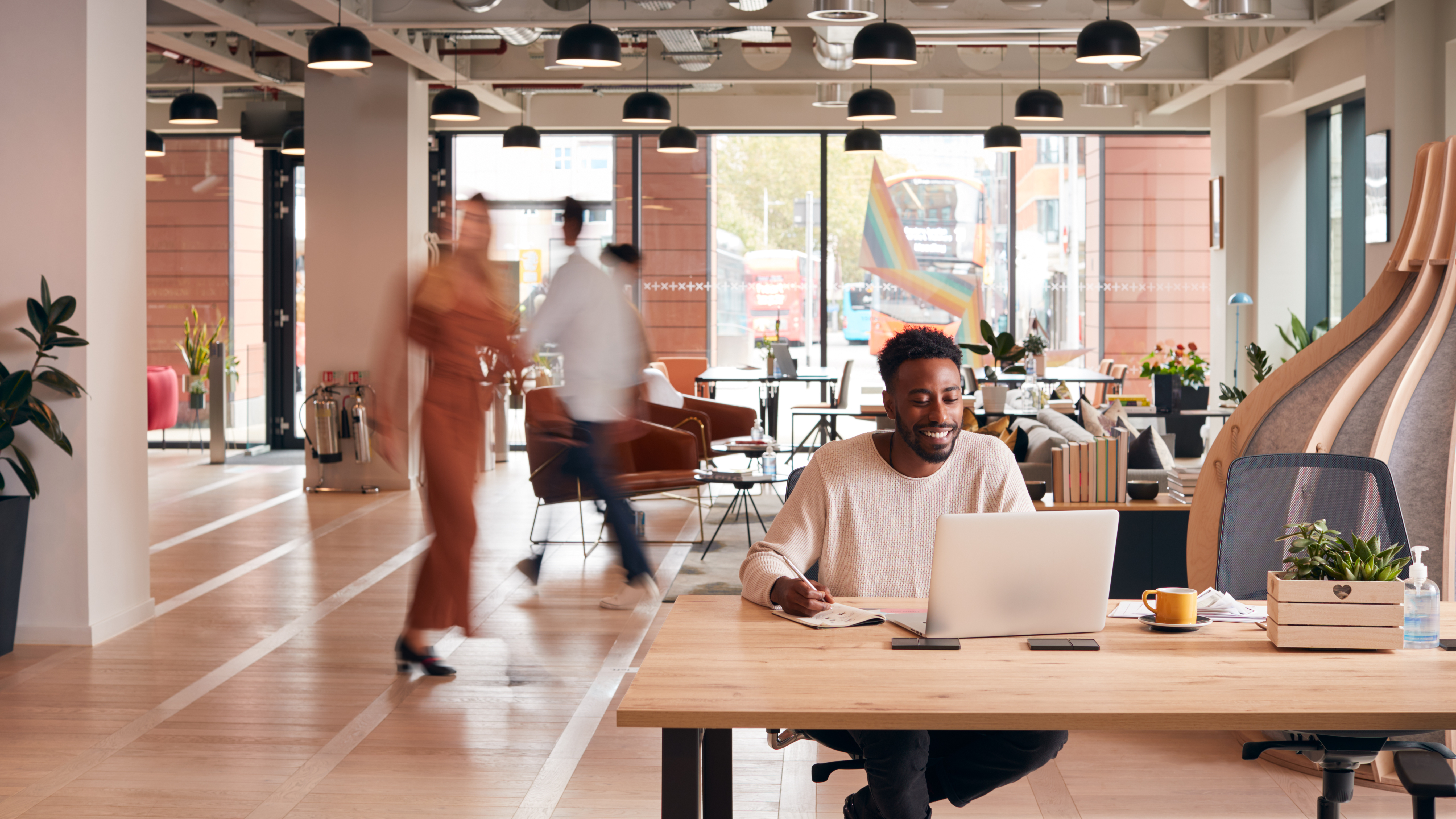 Energy-efficient workplace setting with colleagues at desks.