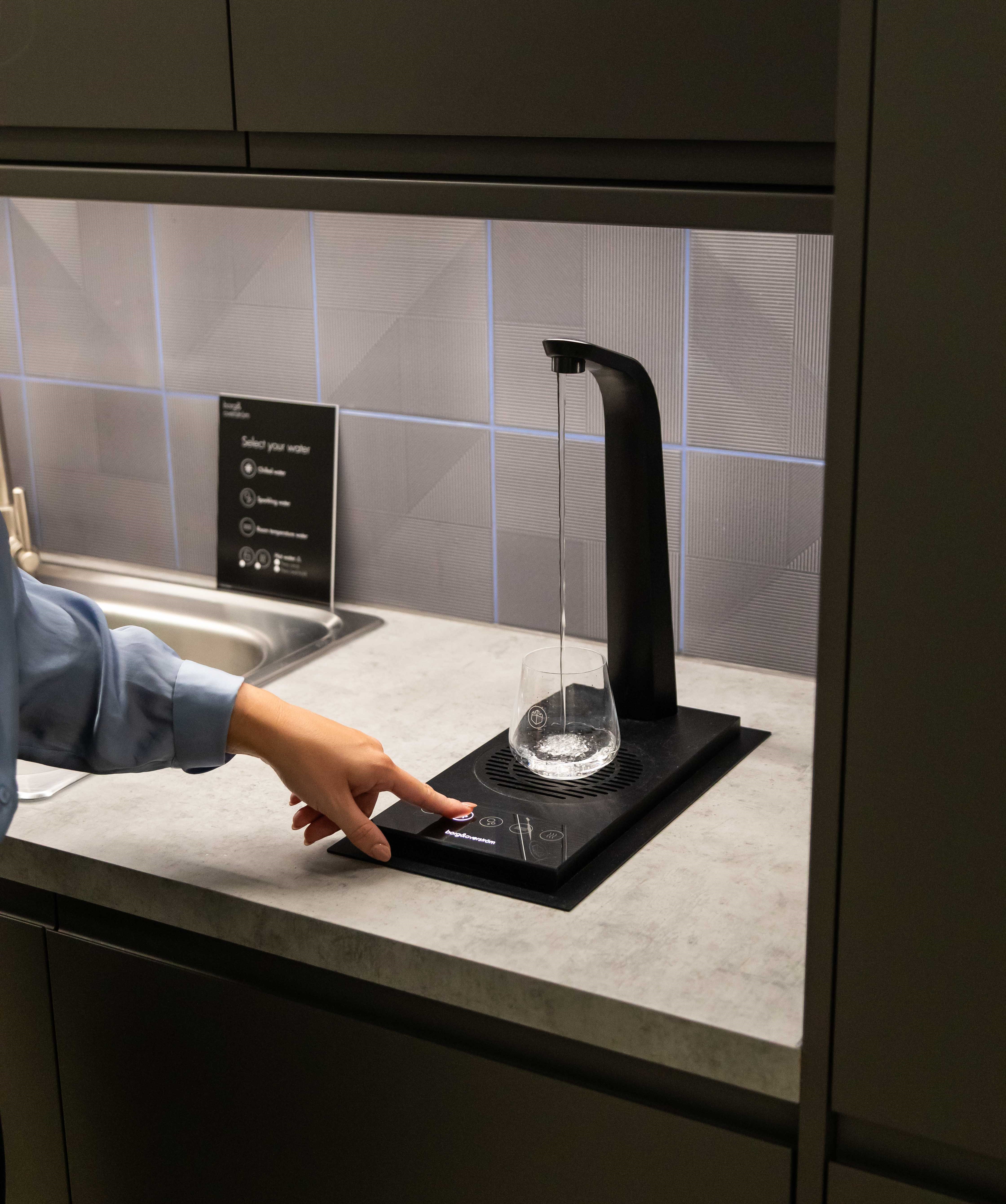 Pouring a glass of water from a T3 integrated drinking water tap